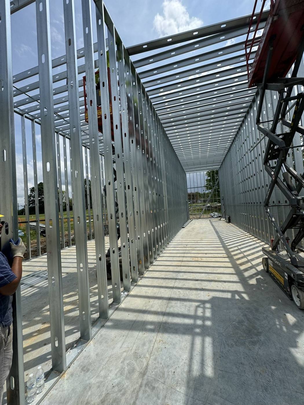 Metal stud framing laid out along a corridor