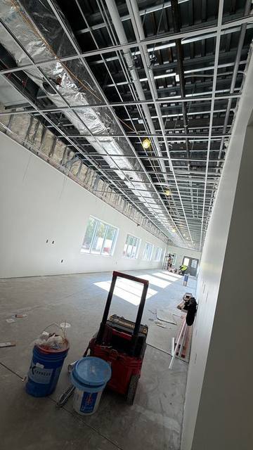 Drywall hung and ceiling grid set