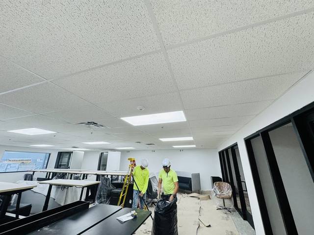 Acoustical ceiling tile going in over a finished office